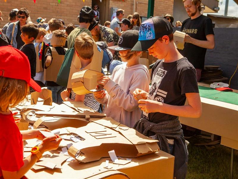 Kids constructing cardboard creations