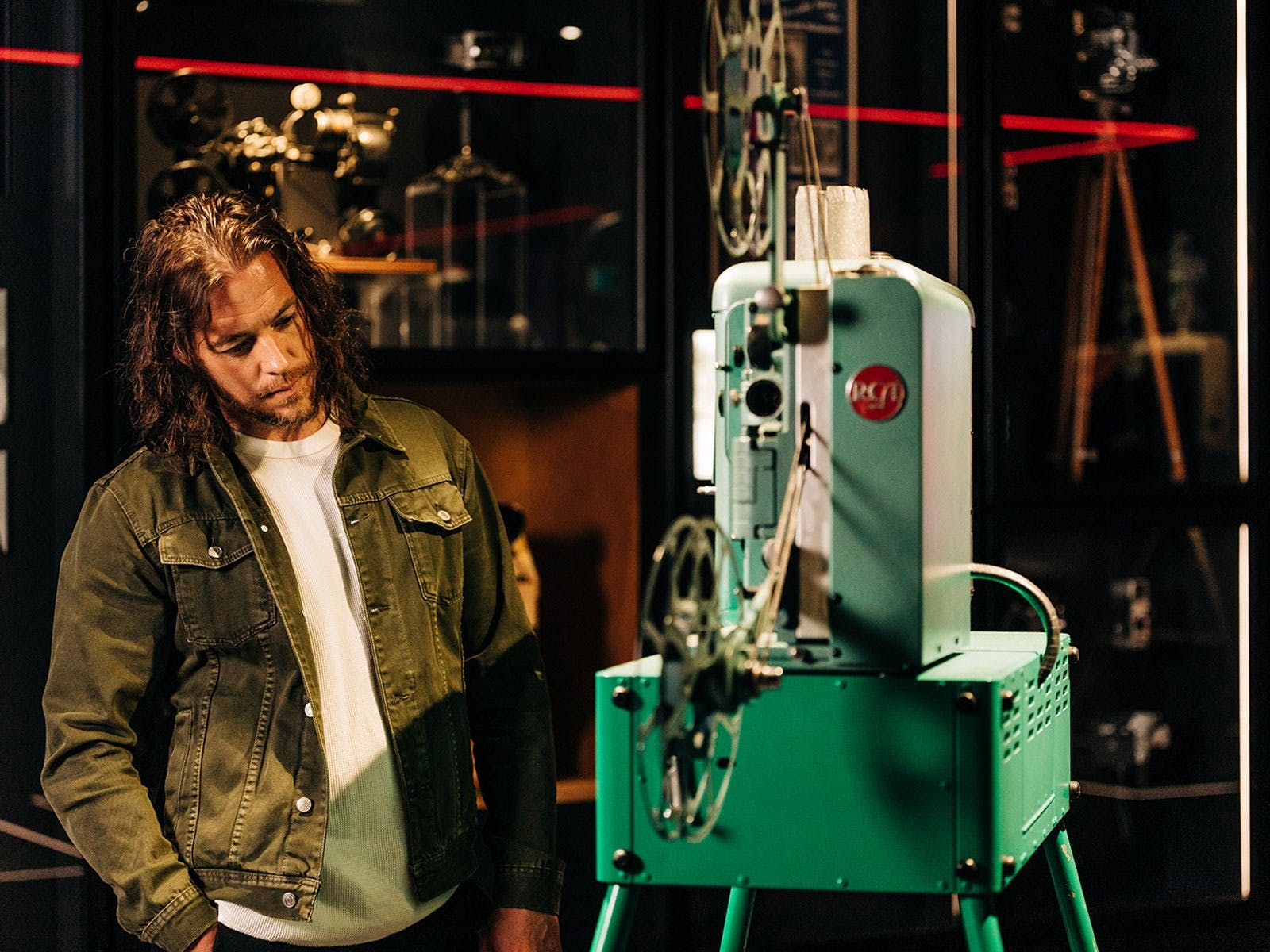 A man looks at a vintage projector