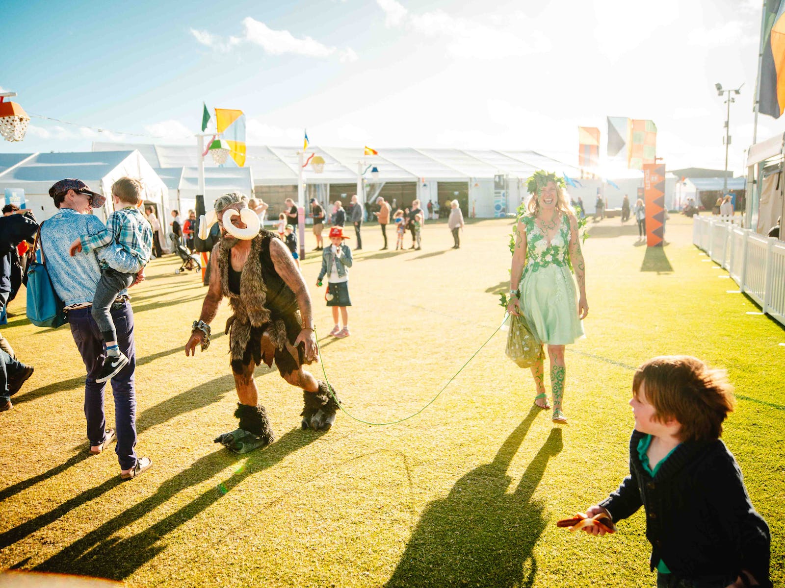 Roving performers at Port Fairy Folk Festival. One is dressed as a green fairy, one as a monster